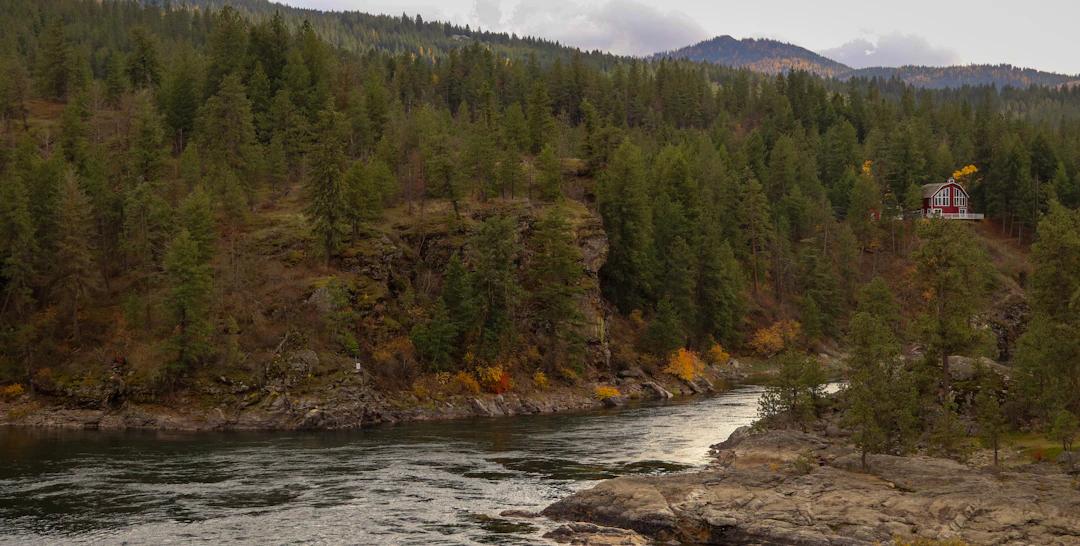 a house on a cliff above a river