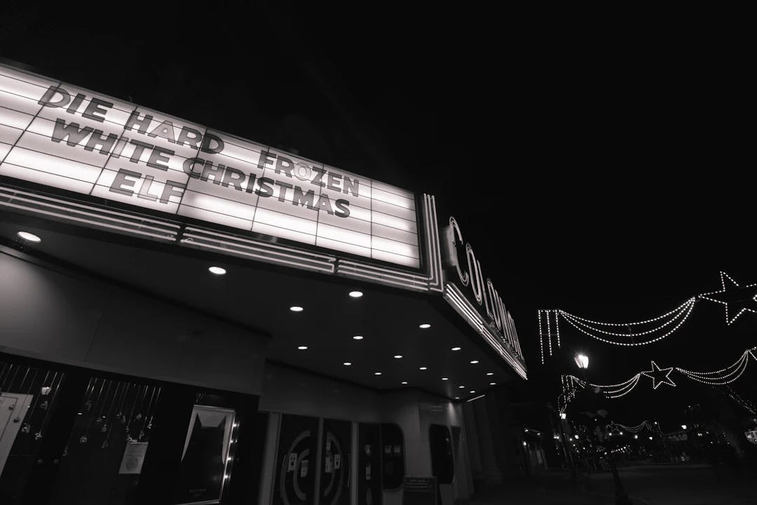 a black and white photo of a theater marquee