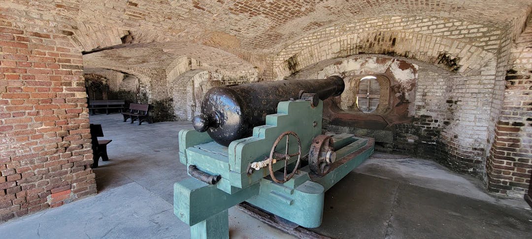 a large cannon in a brick building