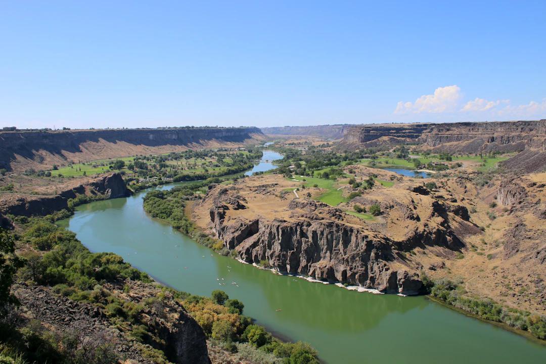 a river running through a lush green valley