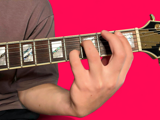 Bb7sus4 guitar chord with finger positions
