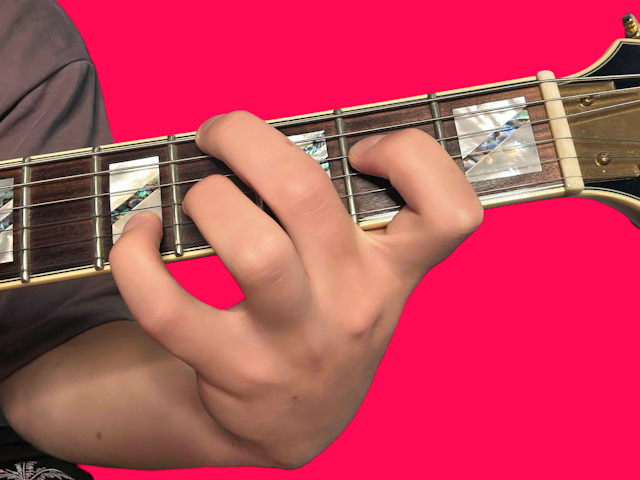 E minor over F guitar chord with finger positions